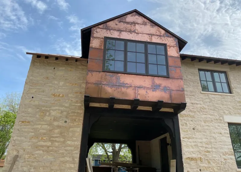 Copper metal panel facade on a stone building for Roof Repair in Rincon Valley