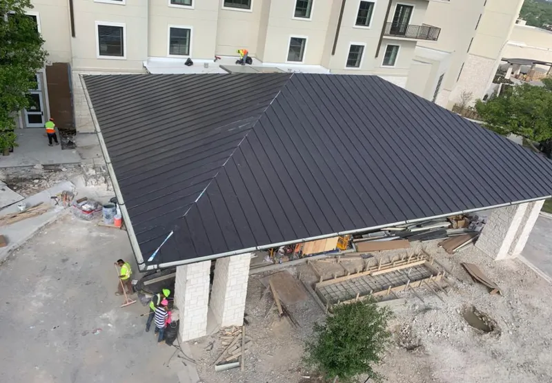 Metal roofing installation team working on a commercial building in Rincon Valley